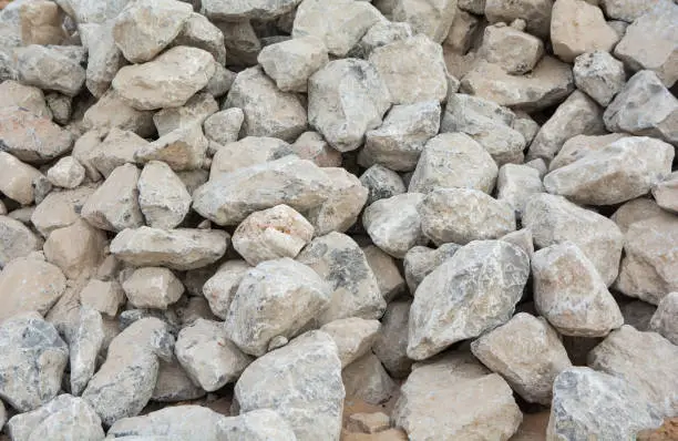 dolomite ore rocks with light gray textured surface and raw mineral formation